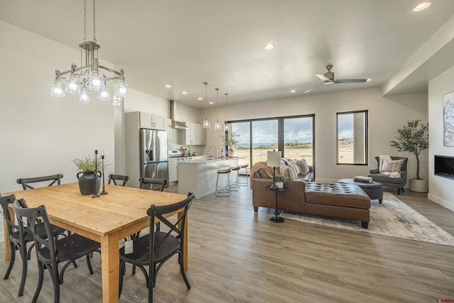 dining area featuring wood-type flooring and ceiling fan