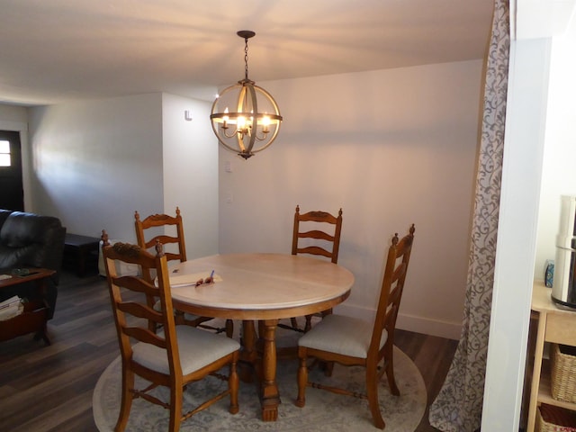 dining area featuring a notable chandelier and dark hardwood / wood-style floors