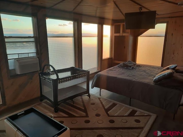 bedroom featuring wooden ceiling and wooden walls