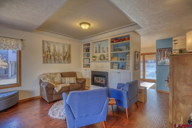 living room with dark hardwood / wood-style flooring and a textured ceiling