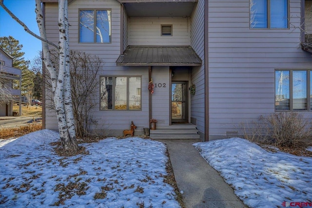 view of snow covered property entrance