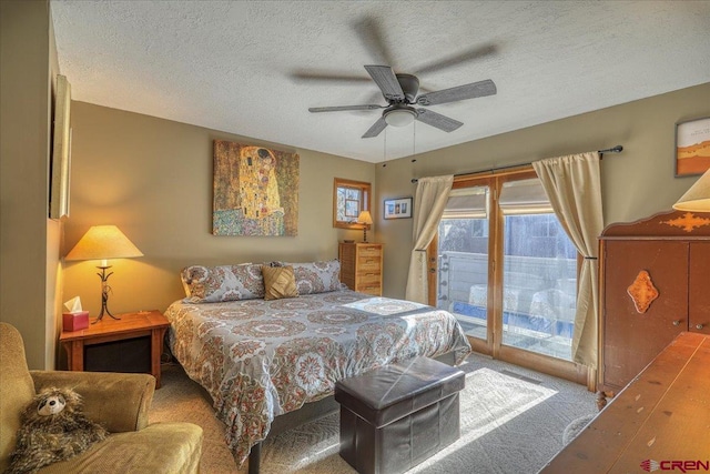 carpeted bedroom with ceiling fan, a textured ceiling, and access to outside