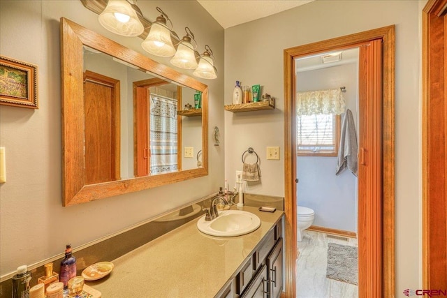 bathroom with vanity and toilet