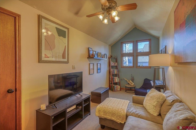 living room featuring ceiling fan, carpet floors, and vaulted ceiling