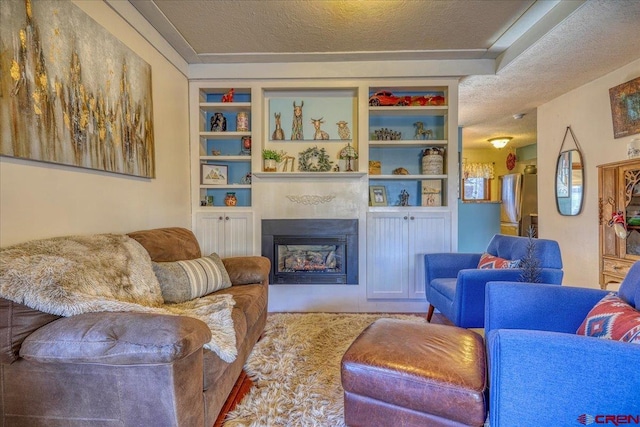 living room with built in features and a textured ceiling