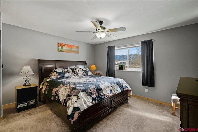 bedroom with ceiling fan and light carpet