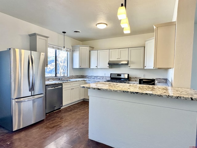 kitchen featuring appliances with stainless steel finishes, sink, white cabinets, hanging light fixtures, and light stone countertops