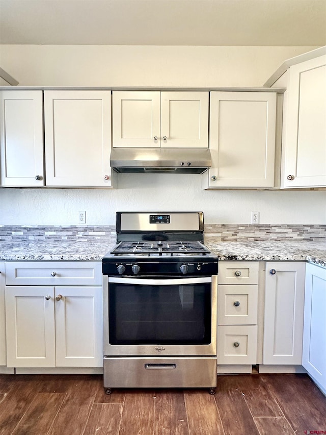 kitchen with light stone counters, white cabinets, and stainless steel gas stove