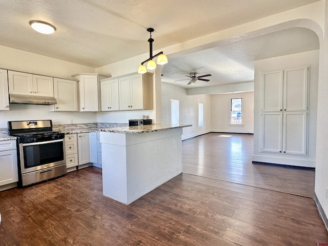 kitchen featuring stainless steel range with gas cooktop, pendant lighting, white cabinetry, dark hardwood / wood-style flooring, and light stone countertops