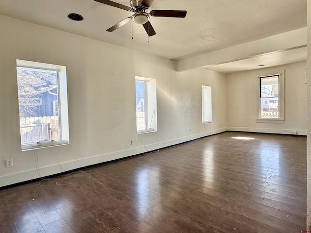 unfurnished room with dark hardwood / wood-style floors and ceiling fan