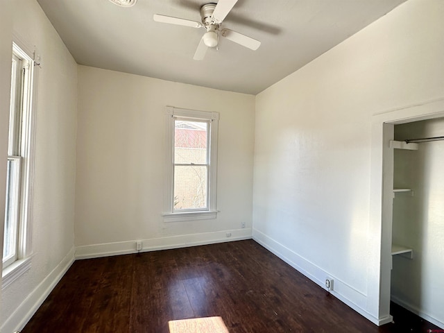 unfurnished room featuring ceiling fan and dark hardwood / wood-style floors