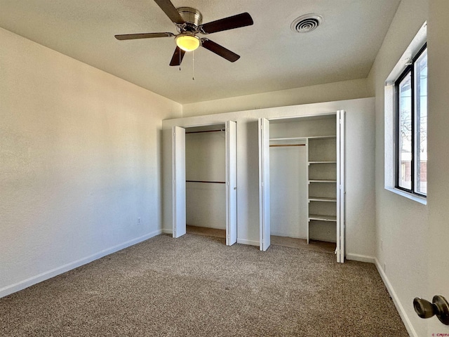 unfurnished bedroom featuring ceiling fan and carpet