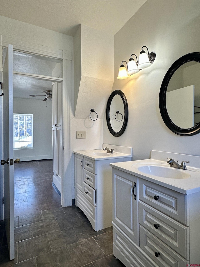 bathroom with ceiling fan and vanity