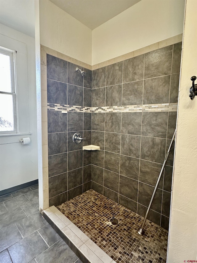 bathroom with a tile shower