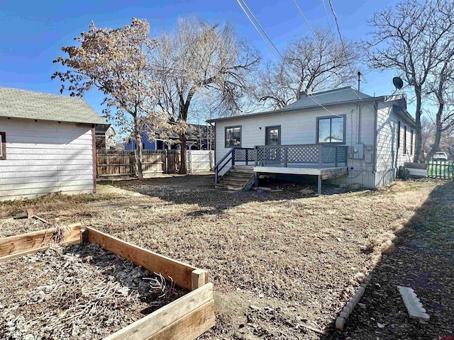 rear view of property with a wooden deck