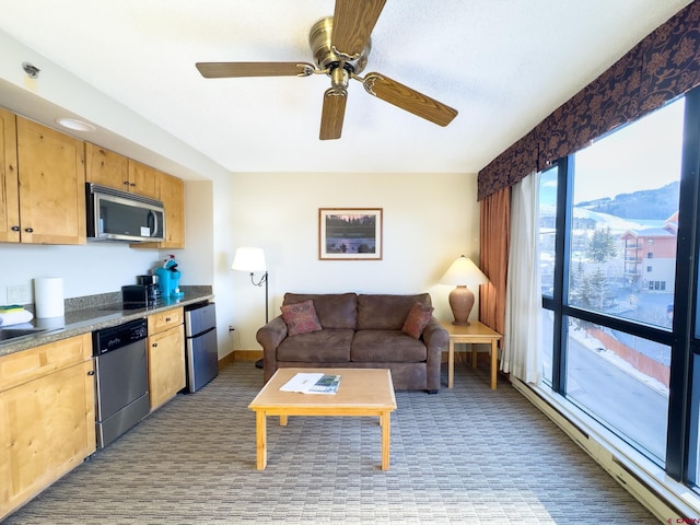 living room featuring a mountain view and ceiling fan