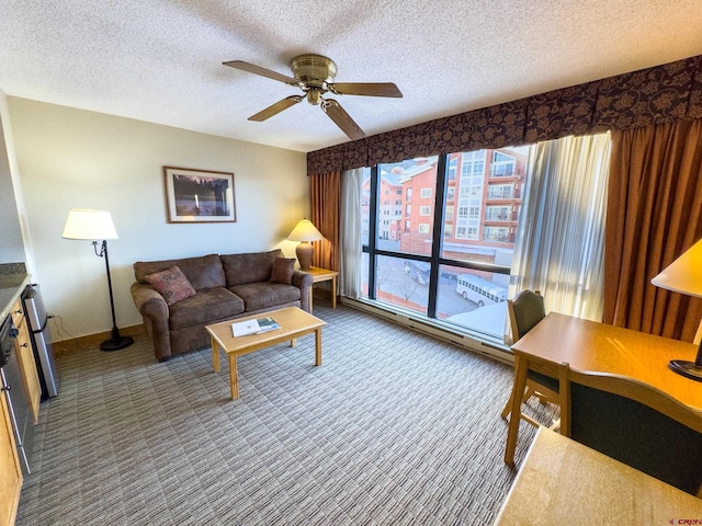 carpeted living room featuring ceiling fan and a textured ceiling