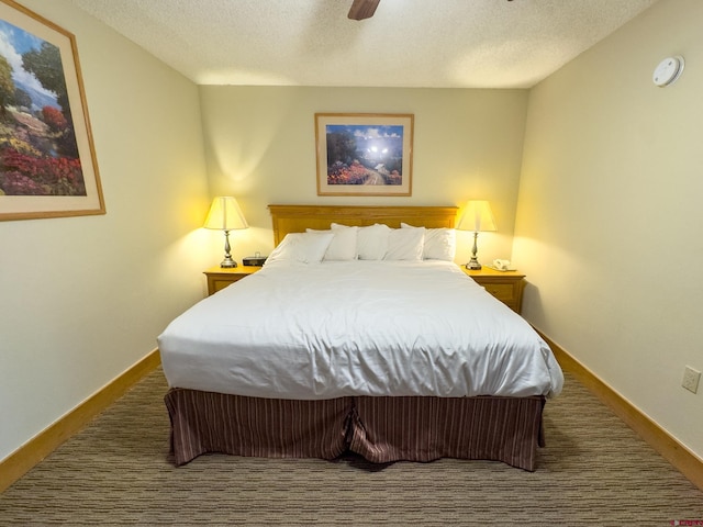 bedroom with ceiling fan and a textured ceiling