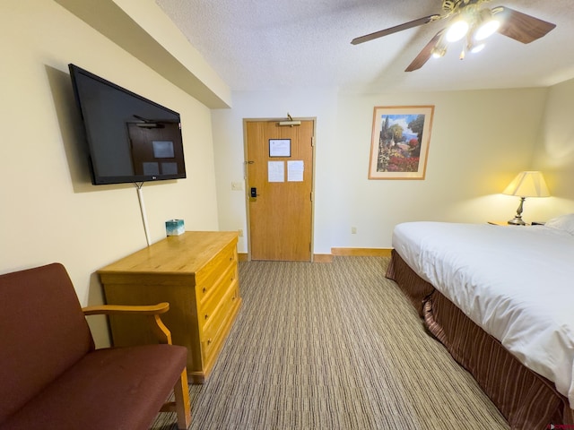 carpeted bedroom with ceiling fan and a textured ceiling