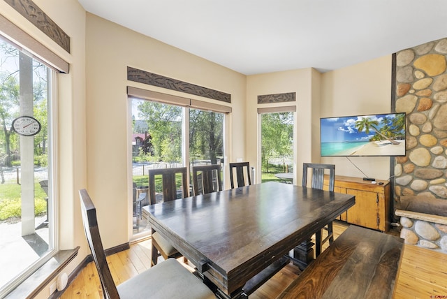 dining space with light hardwood / wood-style flooring