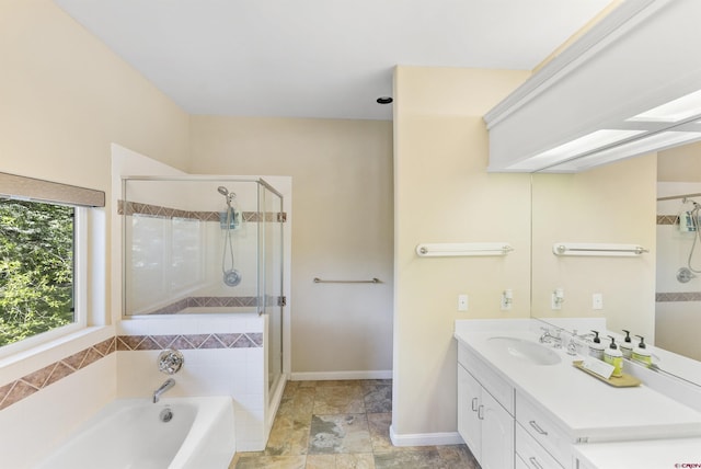 bathroom with vanity and shower with separate bathtub