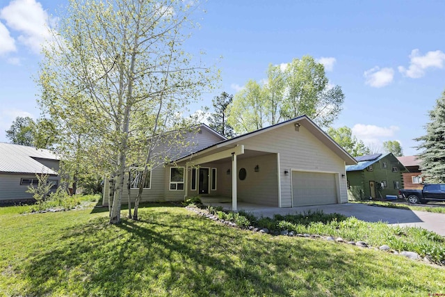 view of front of property featuring a garage and a front lawn