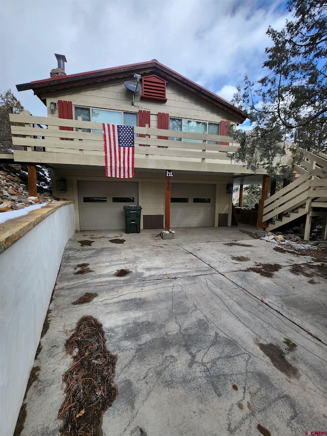 view of front of property with a garage and a balcony