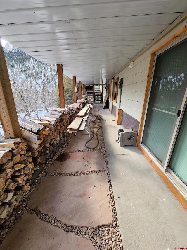 snow covered patio featuring a mountain view