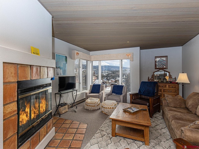 carpeted living room featuring a fireplace and wooden ceiling