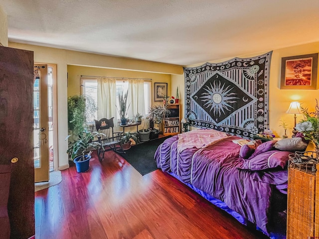 bedroom featuring wood-type flooring and a textured ceiling