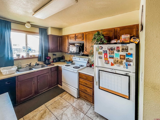 kitchen with light tile patterned floors, sink, a textured ceiling, and black appliances