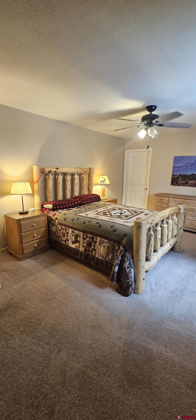 bedroom with carpet floors, a textured ceiling, and ceiling fan