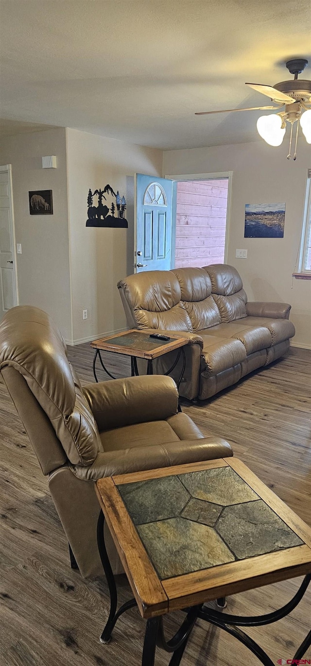 living room featuring dark hardwood / wood-style floors and ceiling fan