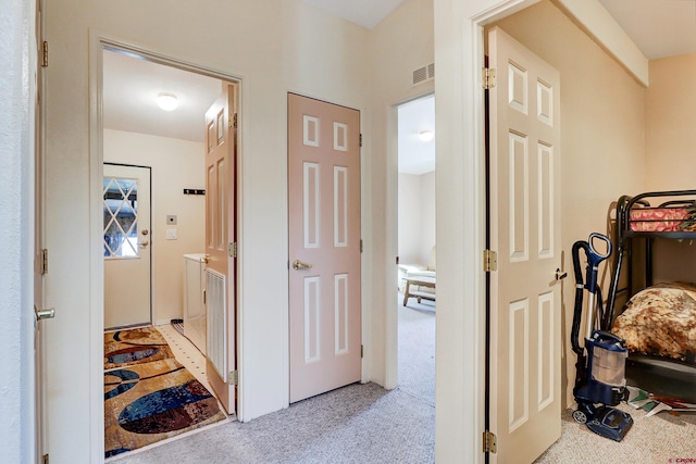 hallway featuring light carpet