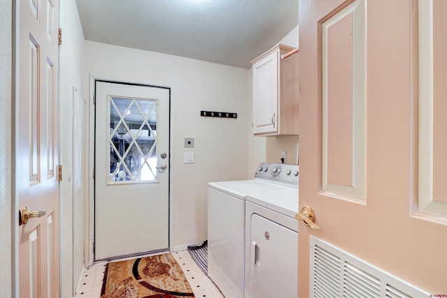 washroom featuring independent washer and dryer and cabinets