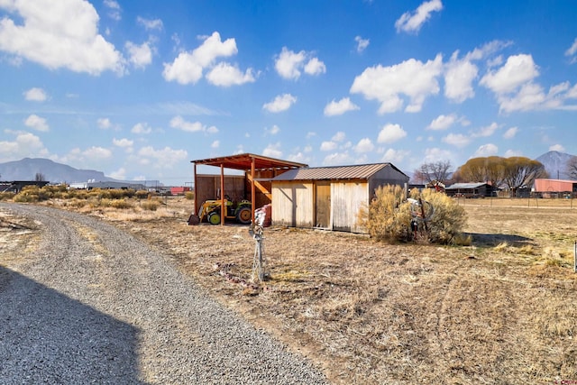 view of front of home with an outbuilding and a mountain view