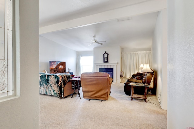 living room featuring ceiling fan and a tiled fireplace