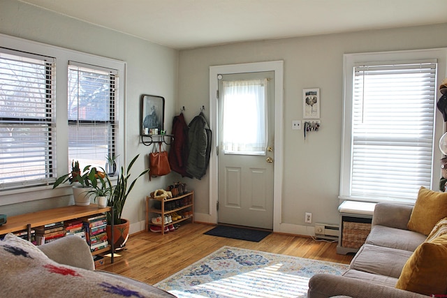 interior space featuring a baseboard heating unit and light hardwood / wood-style floors