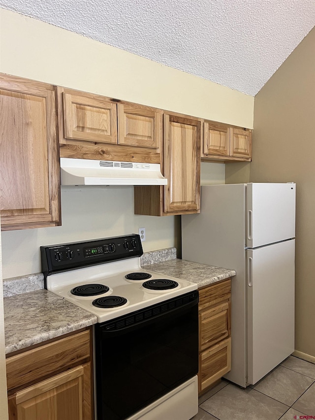 1135 Florida Rd Unit 28, Durango, CO 81301 - kitchen with freestanding refrigerator, a textured ceiling, under cabinet range hood, light countertops, and electric range