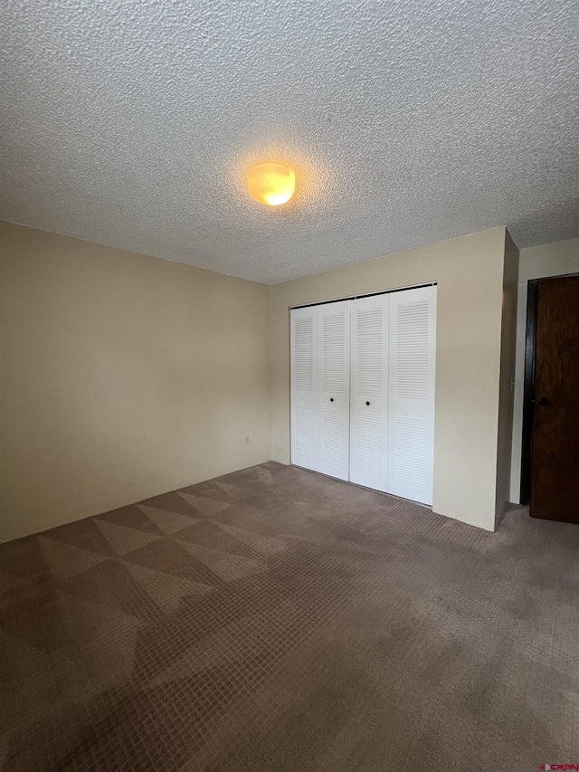 1135 Florida Rd Unit 28, Durango, CO 81301 - unfurnished bedroom featuring carpet flooring, a closet, and a textured ceiling