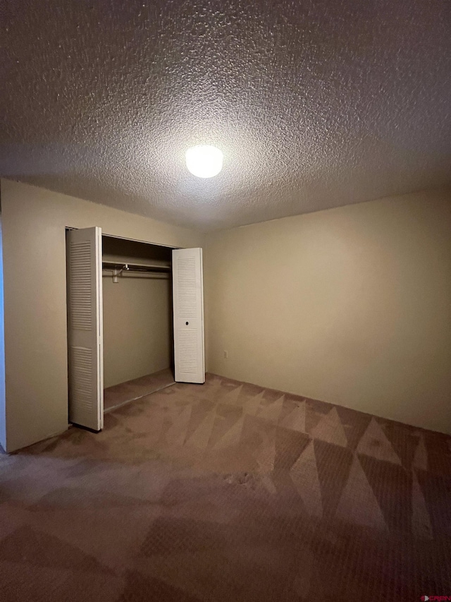 1135 Florida Rd Unit 28, Durango, CO 81301 - unfurnished bedroom with light colored carpet, a closet, and a textured ceiling