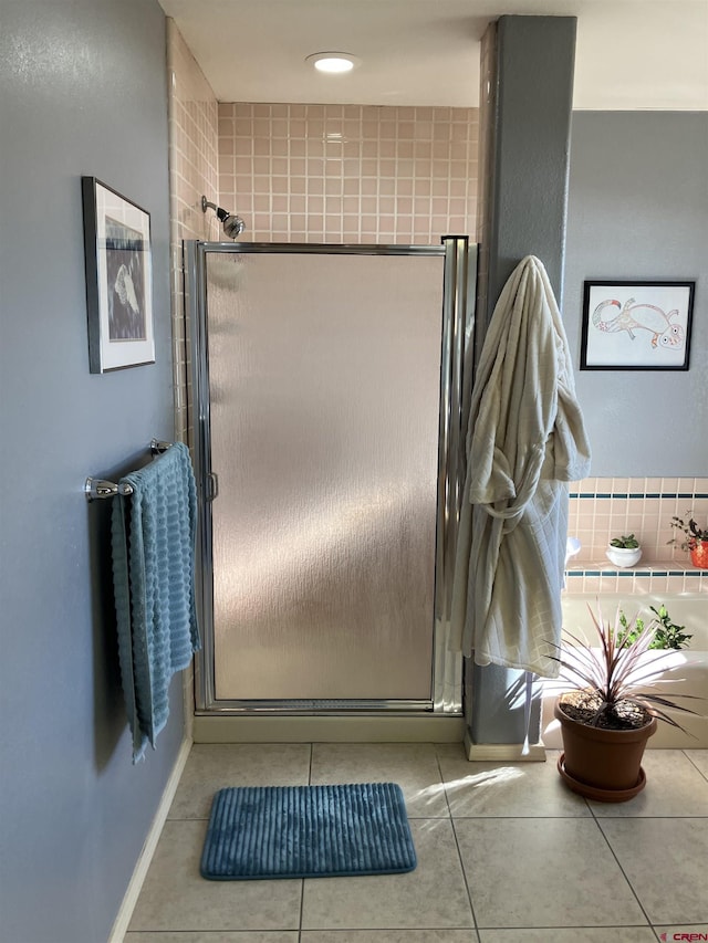 bathroom featuring tile patterned flooring and a shower with door