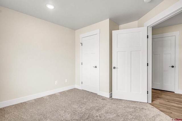 unfurnished bedroom featuring light colored carpet