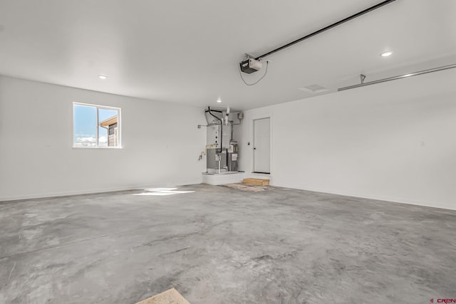 garage with a garage door opener and electric water heater