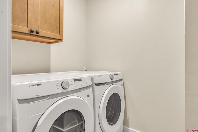 laundry area featuring cabinets and separate washer and dryer