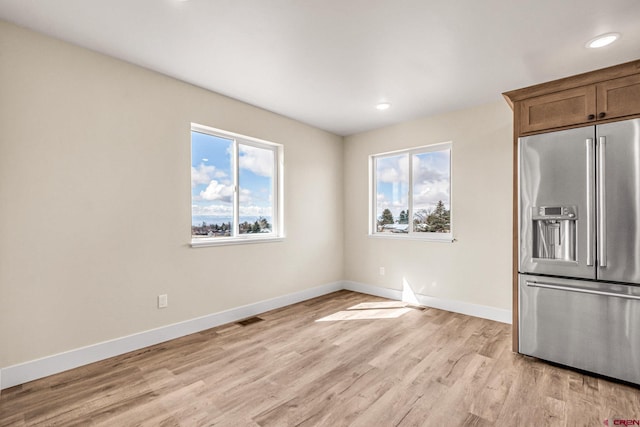 kitchen featuring high quality fridge and light hardwood / wood-style floors