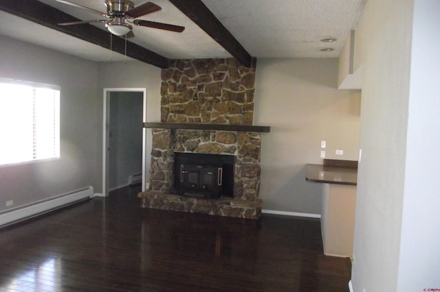 unfurnished living room featuring dark wood-type flooring, ceiling fan, baseboard heating, a textured ceiling, and beamed ceiling