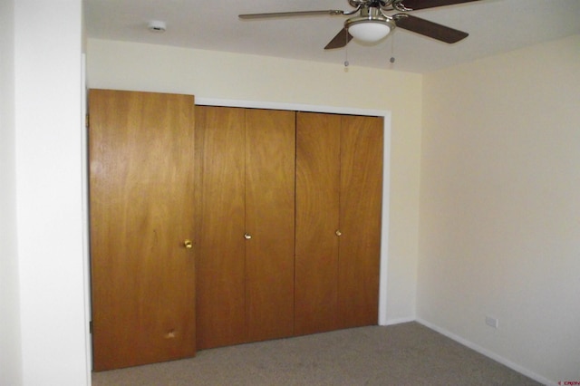 unfurnished bedroom with light carpet, a closet, and ceiling fan