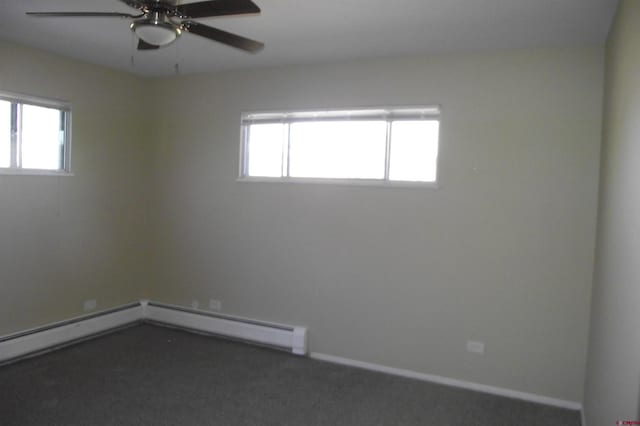 carpeted spare room featuring ceiling fan, a healthy amount of sunlight, and baseboard heating