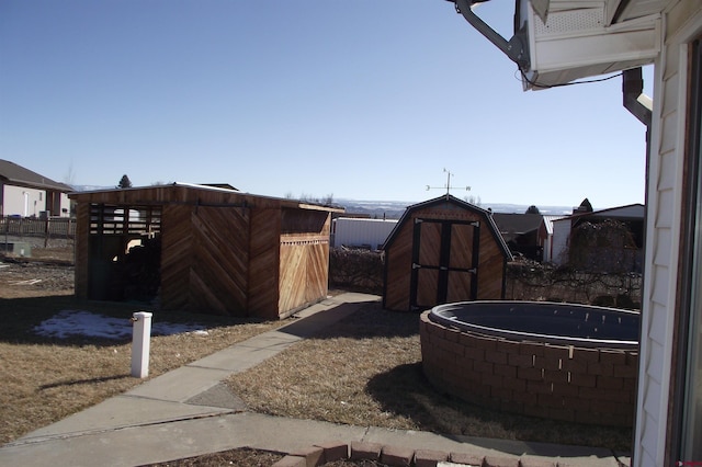 view of yard featuring a trampoline and a shed